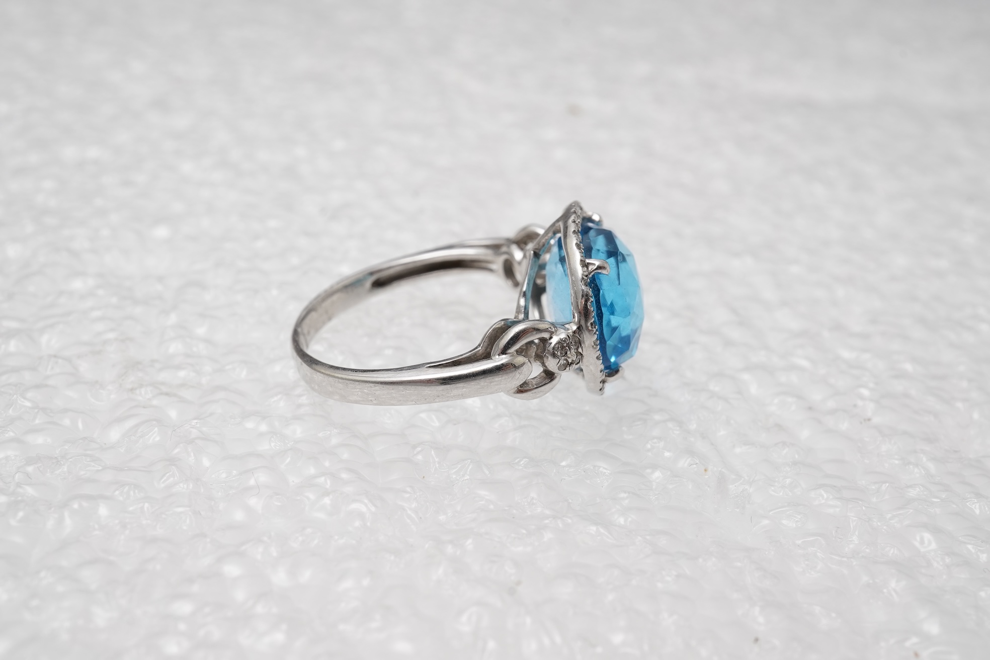 A blue topaz and diamond ring